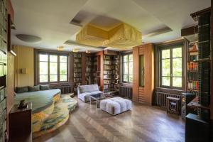a living room with a couch and chairs and books at Castle Horizon Suite in Budapest +14 photos