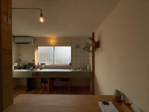 a small kitchen with a sink and a window at Nagi Unoport 2 in Tamano
