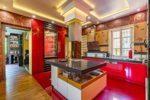 a large kitchen with red and yellow walls at Castle Horizon Suite in Budapest