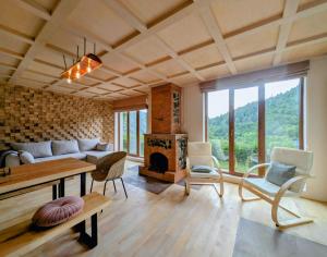 a living room with a couch and a fireplace at Eko cottages in Borjomi