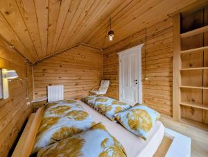 a bedroom with a bed in a wooden room at Eko cottages in Borjomi +52 photos