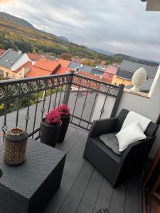 a balcony with a chair and a table at ROYAL Apartment in Kadaň