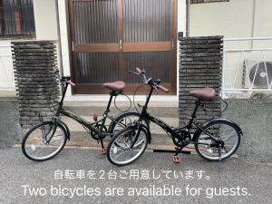 two bicycles are parked in front of a building at MYOJI HOUSE 2 Traditional Japanese Stay in Katsuragi