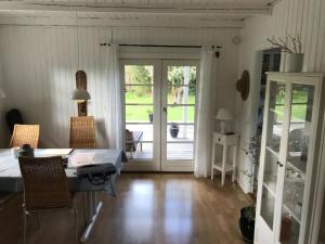 a room with a table and chairs and a sliding glass door at Stunning Home In Nykøbing Sjælland W in Nykøbing Sjælland