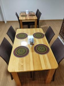 a wooden table with four chairs around it at Sahro Hotel in Bukhara +34 photos
