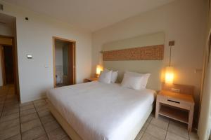 Giường trong phòng chung tại The Navigator - Colombus Apartments & Villas