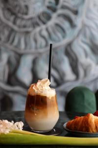 a drink sitting on a table with a plate of food at VISIONAPARTMENTS Bucharest - self check-in in Bucharest +71 photos