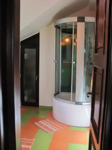 a bathroom with a shower and a colorful floor at Casa Roatis in Şişeşti