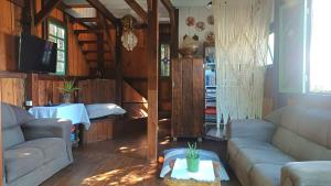 a living room with two couches and a table at Maia House Hostal in Florianópolis