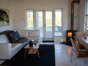 a living room with a white couch and a fireplace at The Barn On 62 - Cottages in Montagu