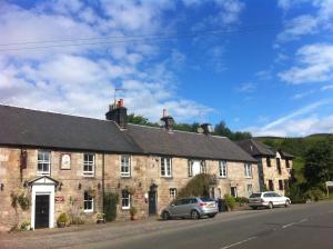 an old stone building with cars parked in front of it at 2 bed apartment & parking, Carlops,10 mins drive Edinburgh bypass in Carlops