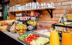 a buffet with fruits and vegetables on a table at 7Days B&B in Bratislava