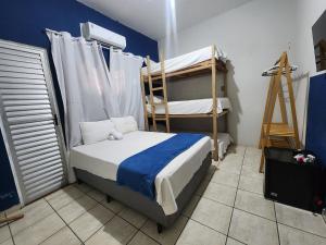 Un dormitorio con dos literas y una escalera. en Mini Hostel, en Tutóia