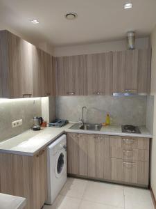 a kitchen with a sink and a washing machine at Yerevan Hotel in Yerevan