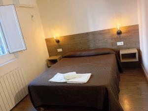 a bedroom with a bed with two towels on it at Bearan Rooms 2 in Pamplona