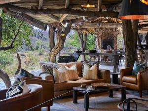 a living room with a couch and chairs and a table at Toro River by NEWMARK in Makalali Game Reserve +125 photos