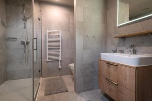 a bathroom with a sink and a toilet and a shower at DaSus Luxury Tále in Tale +26 photos