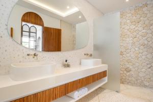 een badkamer met een wastafel en een spiegel bij Ocean Verve Villa 2 - 3bd in central Uluwatu in Bingin Beach