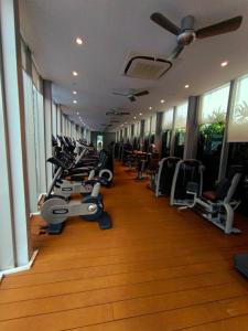 a gym with a row of treadms and machines at KLCC Sky Villa Suites Vortex in Kuala Lumpur