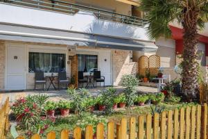 a fence in front of a house with plants at Billy's Luxury Suites - 2 by Booking Kottas - Kriopigi in Kriopigi