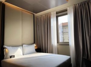a bedroom with a bed and a window at 7BA Hotel Milano in Milan