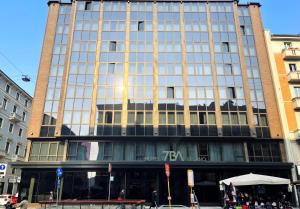 a tall building with a lot of windows on a street at 7BA Hotel Milano in Milan