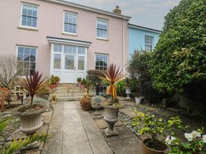 a house with potted plants in front of it at Scillonia in Penzance