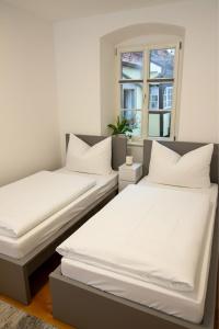 Postel nebo postele na pokoji v ubytování Sand Altstadt Apartments