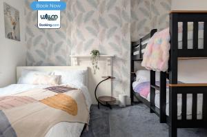 a bedroom with a bed and bunk beds in it at 3 Bedroom House By WillCo Property Short Lets & Serviced Accommodation Leicester With Games, Parking, Projector & Perfect For Contractors in Leicester