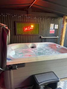 a jacuzzi tub in a room with a sign at CHRISTMAS Woodlands Lodge & Hottub in Skegness