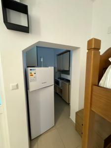a small kitchen with a refrigerator in a room at Prinnos Rooms Himare in Himare