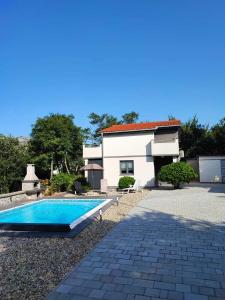 a swimming pool in front of a house at Villa Solterra in Grižane