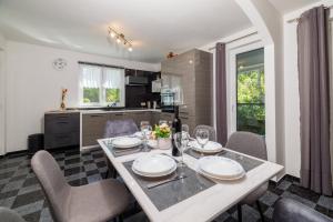 a kitchen and dining room with a table and chairs at Villa Solterra in Grižane