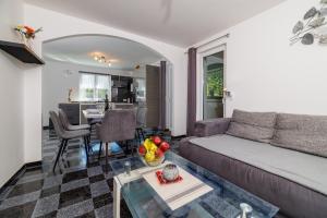a living room with a couch and a table at Villa Solterra in Grižane +33 photos