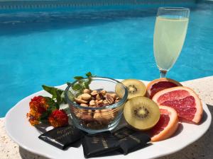 a plate of fruit and nuts and a glass of milk at Casa Alta - villa med privat svømmebasseng in Ciudad Quesada