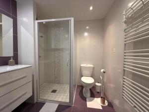a bathroom with a toilet and a glass shower at Le Verger - Gite 8 personnes en campagne et rivière By Primo in La Forêt-sur-Sèvre +51 photos