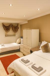 a bedroom with two beds and a window at Stunning home next to Excel, London City Airport and East London University in North Woolwich