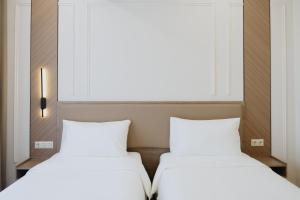 Ένα ή περισσότερα κρεβάτια σε δωμάτιο στο Bon Hotel Bishkek