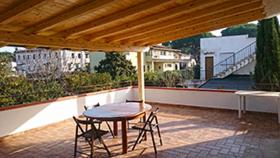 a patio with a table and chairs on a roof at Edvige'S House in San Felice Circeo