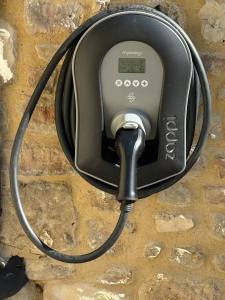 a telephone hanging on a stone wall at Recently converted barn on the outskirts of Bath in Radstock