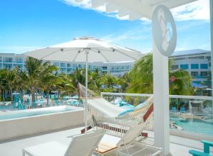 プエルト・モレロスにあるMargaritaville Island Reserve Riviera Maya - An Adults Only Karisma All-Inclusive Experienceのポーチ(ハンモック、スイミングプール付)