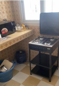 eine Küche mit einem schwarzen Herd und einer Theke in der Unterkunft Nord foire studio meublé à Dakar in Dakar
