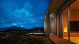 a house with a view of the mountains at Lodge 9 - Amazing cabin in Lyngvær in Storøya