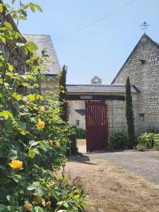 a barn with a wooden door in a yard at Le prieuré in Raslay +3 photos