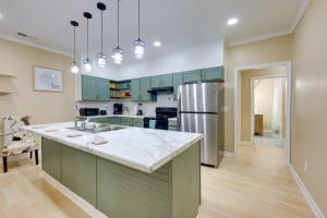 a kitchen with green cabinets and a stainless steel refrigerator at Less Than 10 Mi to UAB Birmingham Group Getaway in Fairfield
