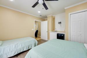 a bedroom with two beds and a ceiling fan at Less Than 10 Mi to UAB Birmingham Group Getaway in Fairfield