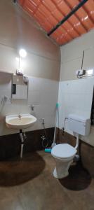 a bathroom with a toilet and a sink at Saraswati Vinayak Villa in Dapoli, Konkan in Dapoli