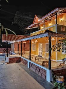 a house with a pavilion in front of it at night at Saraswati Vinayak Villa in Dapoli, Konkan in Dapoli