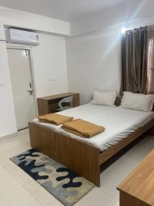a bedroom with a bed in a room at The Grand Inn - Kempegowda Airport Bangalore in Devanahalli-Bangalore