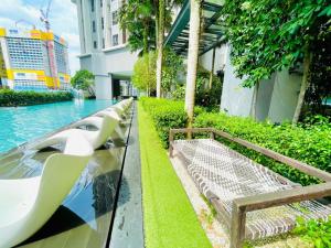 a bench sitting next to a pool in a building at KLCC Sky Villa Suites The Mews in Kuala Lumpur